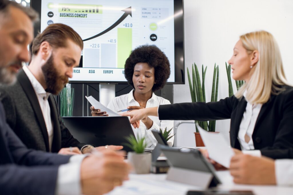 Discussion, business, and teamwork concept. Group of multiethnic businesspeople, having discussion